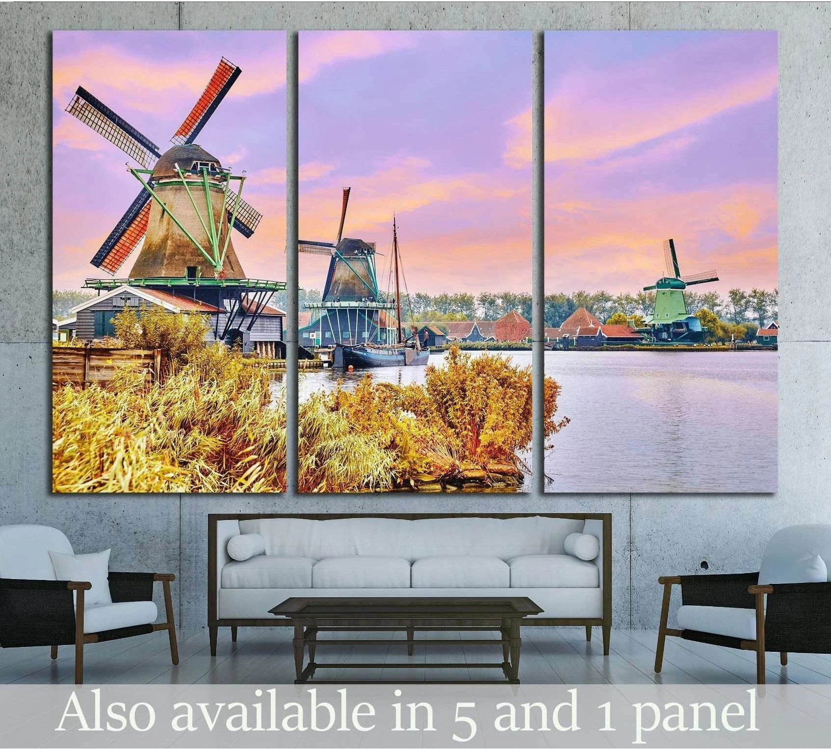 Triptych Dutch windmills canvas print above sofa with pastel sunset sky and canal in a modern living room