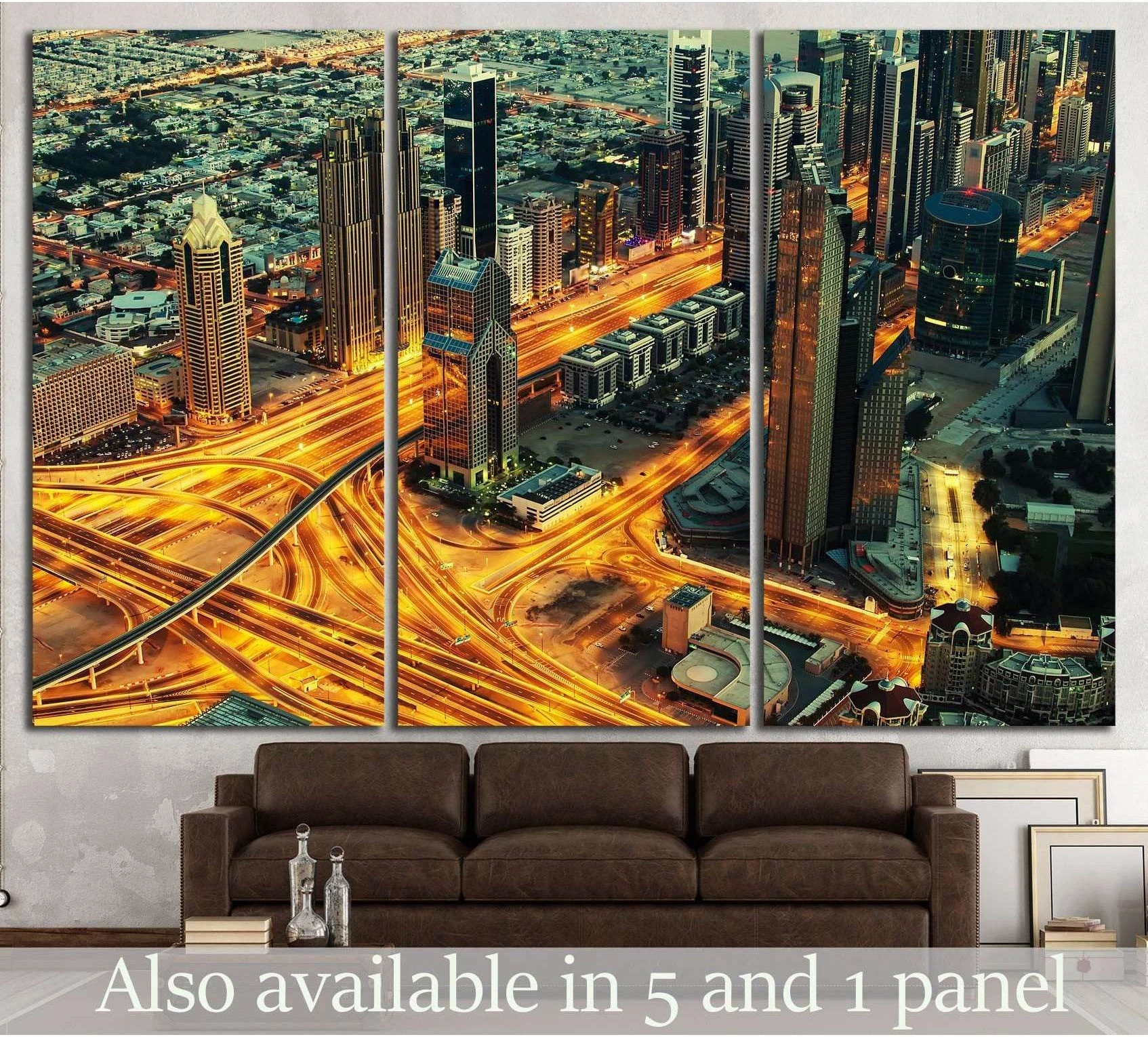 Dubai night skyline canvas print above sofa with glowing highway interchanges and skyscrapers