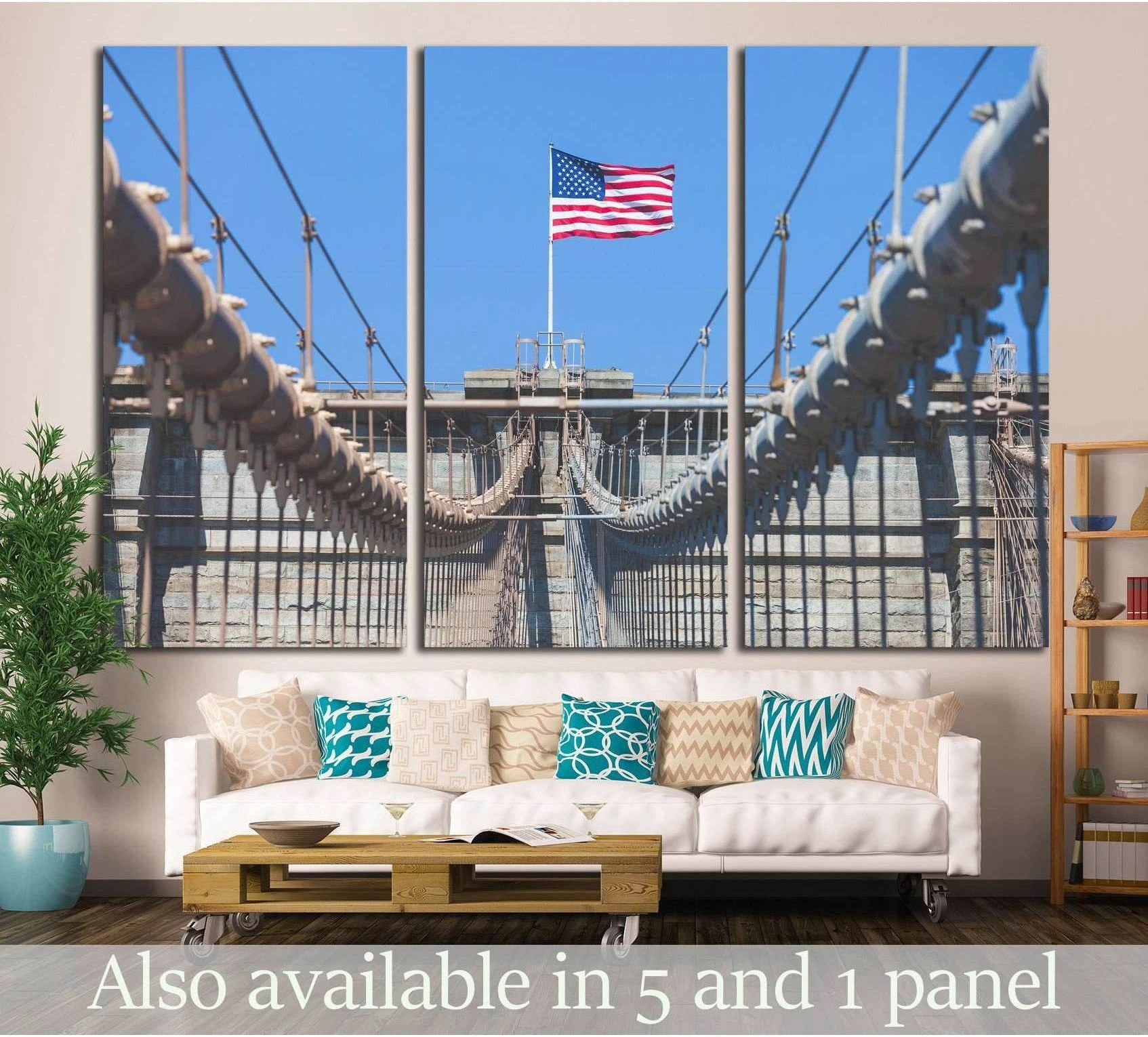 Brooklyn Bridge canvas print with American flag above the walkway, displayed above a sofa in a modern living room