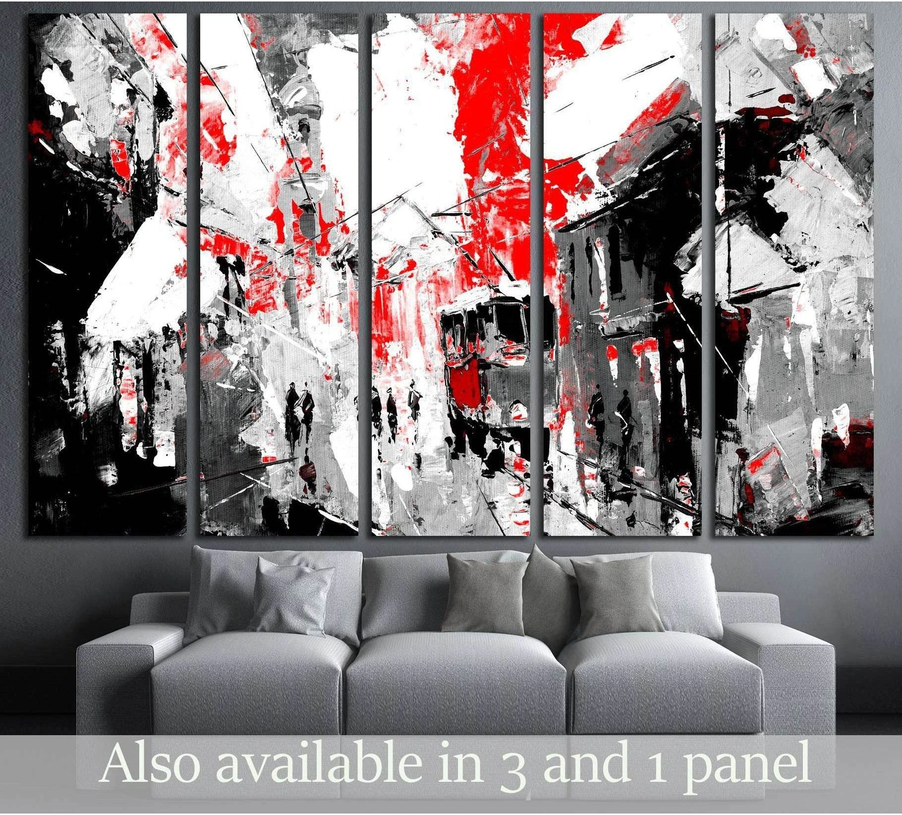 Red and black abstract city canvas print with tram and pedestrians, displayed above a gray sofa