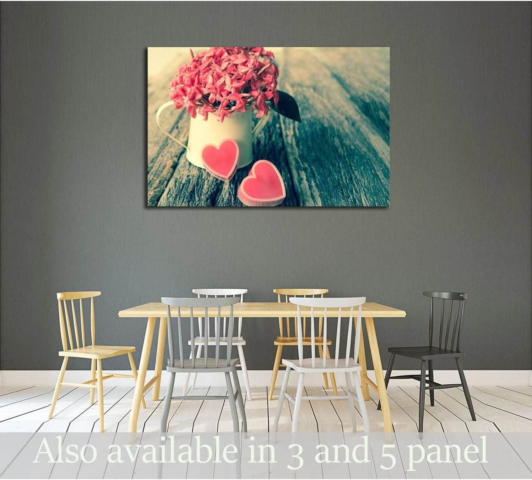 Valentine heart canvas print showing pink flowers in a white cup with two pink hearts on rustic wooden boards, hung above a dining table in a modern room