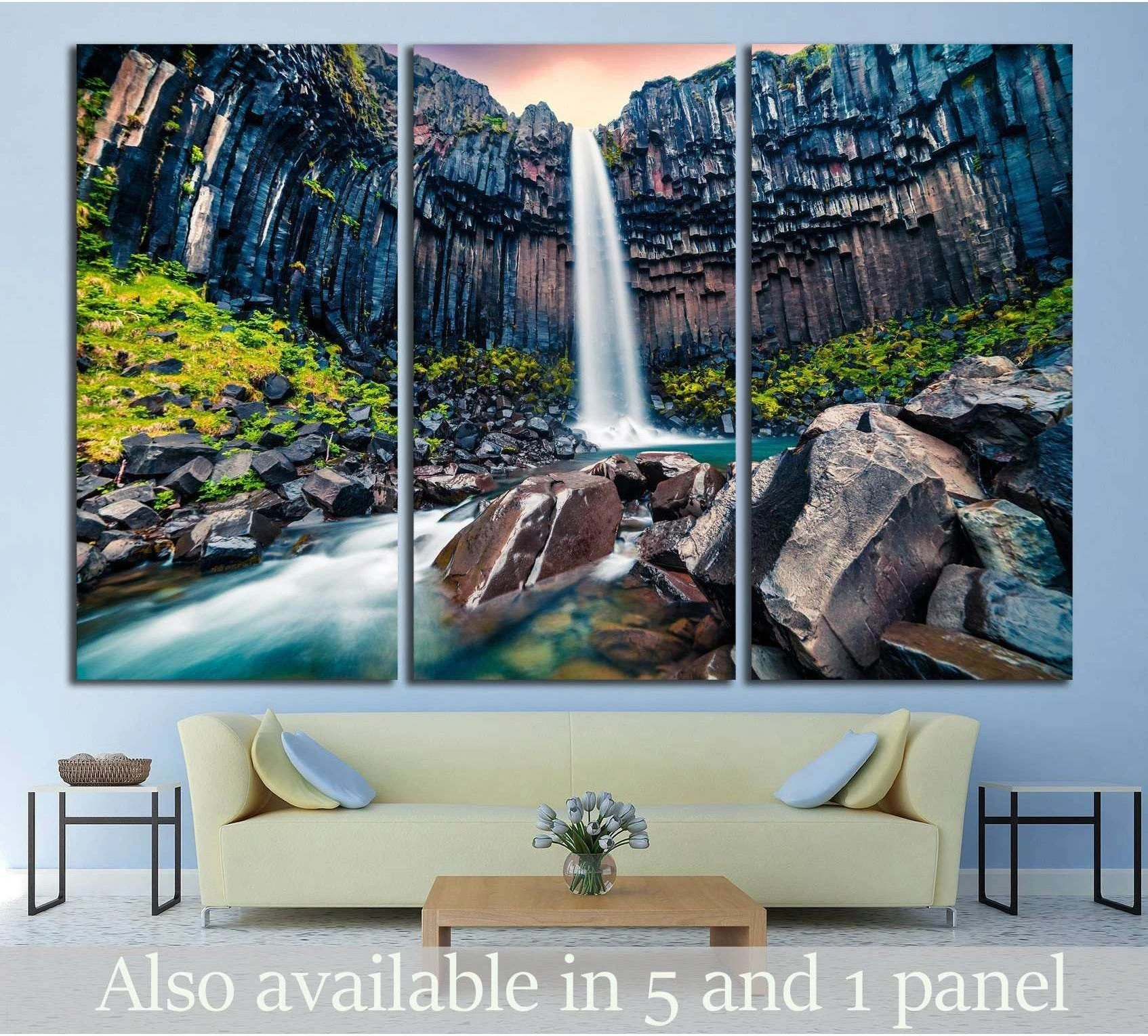 Svartifoss waterfall canvas print with basalt cliffs and mossy rocks above a sofa in a modern living room