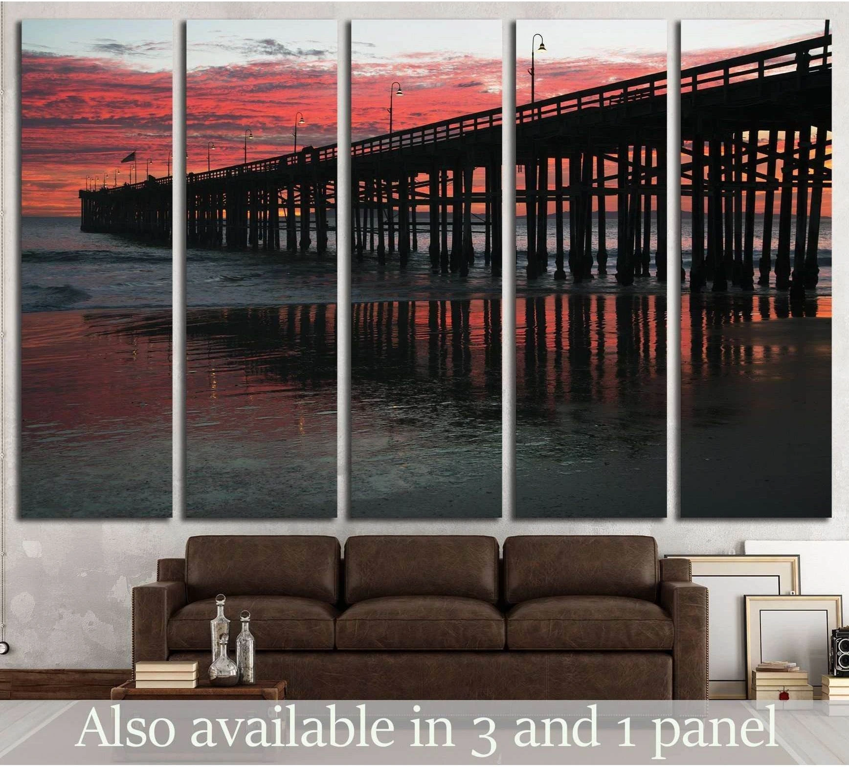 Ventura Pier sunset canvas print with dark pier silhouette and pink sky above a sofa