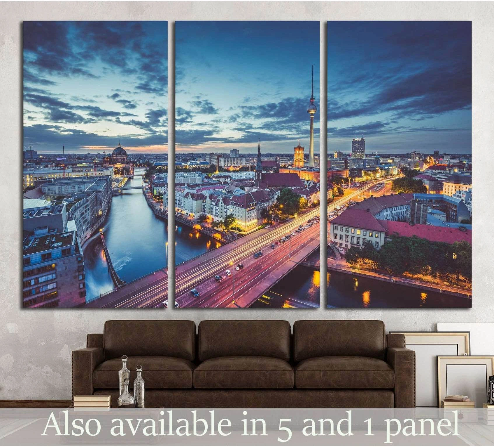 Berlin skyline triptych canvas print with Spree River and TV Tower at twilight above a brown sofa