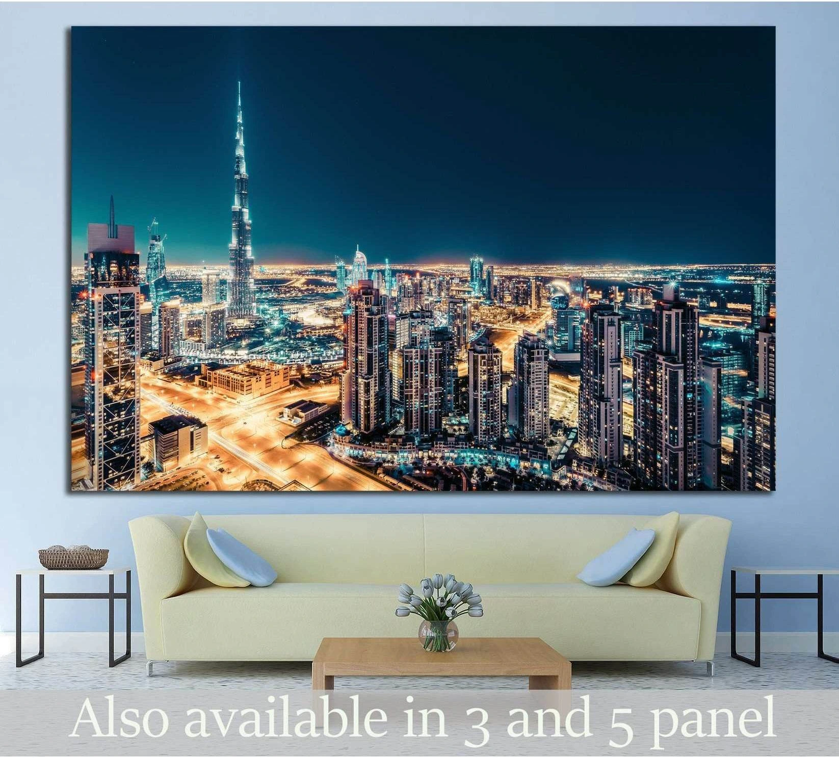 Dubai skyline canvas print with Burj Khalifa at night above a sofa in a modern living room
