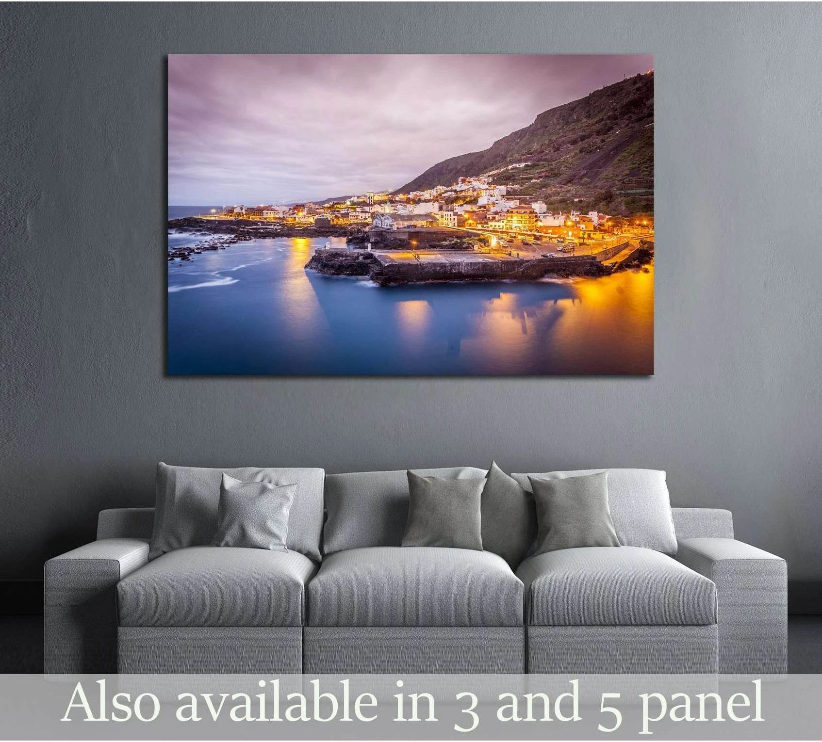 Garachico Tenerife coastal canvas print with evening lights above a sofa in a modern living room