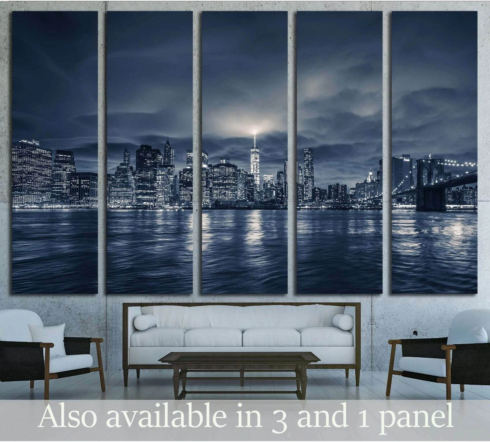 Manhattan night skyline canvas print with Brooklyn Bridge above a sofa in a modern living room