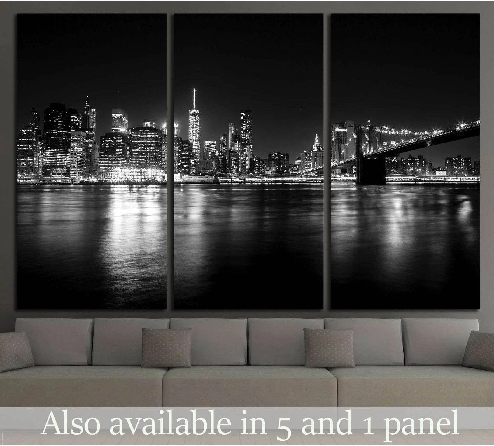 Black and white Manhattan skyline canvas print with Brooklyn Bridge above sofa in modern living room