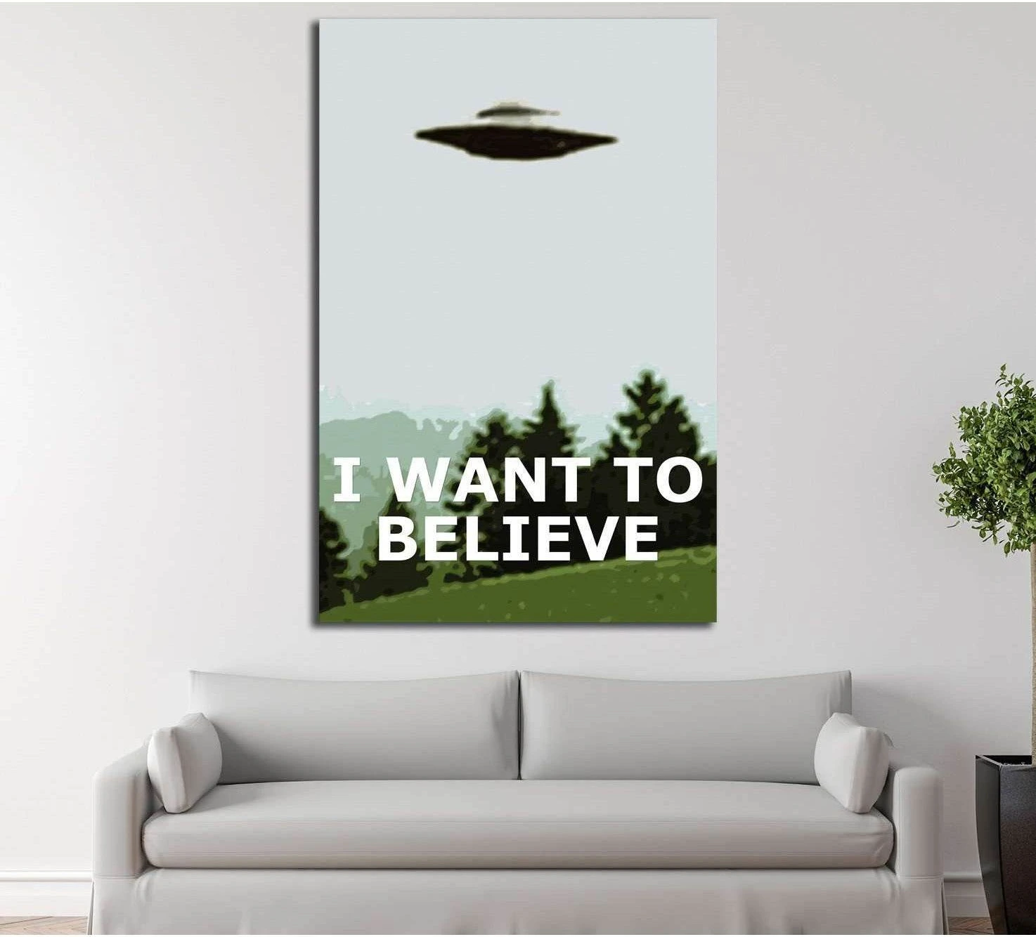 I Want to Believe UFO canvas print hung above a sofa in a modern living room