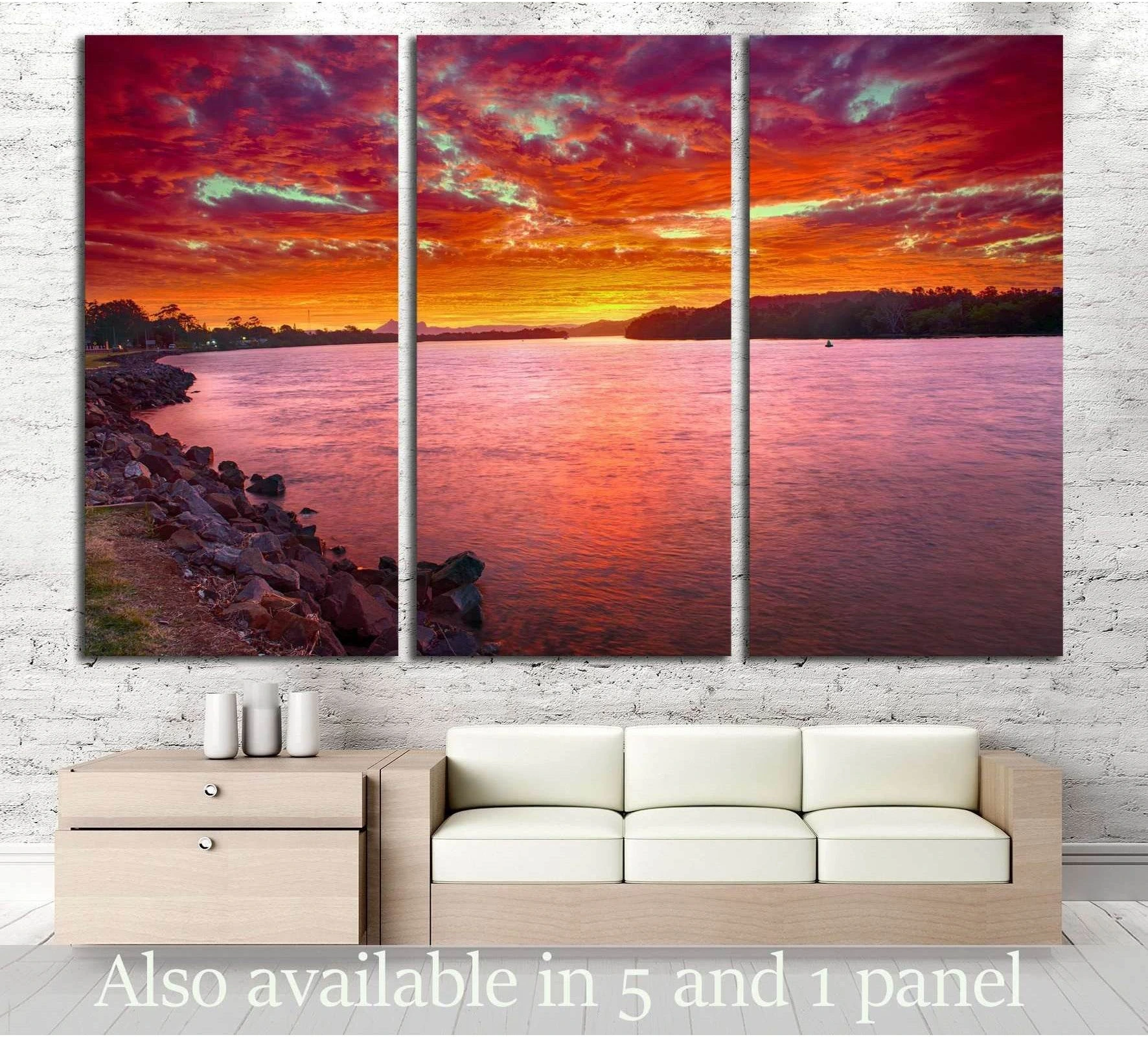 Triptych Australian sunset canvas print above sofa with red orange sky over calm river water