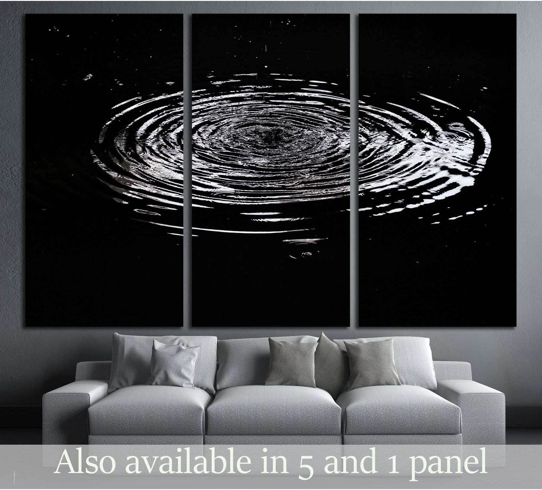Black and white water ripples canvas print displayed as a triptych above a sofa in a modern living room