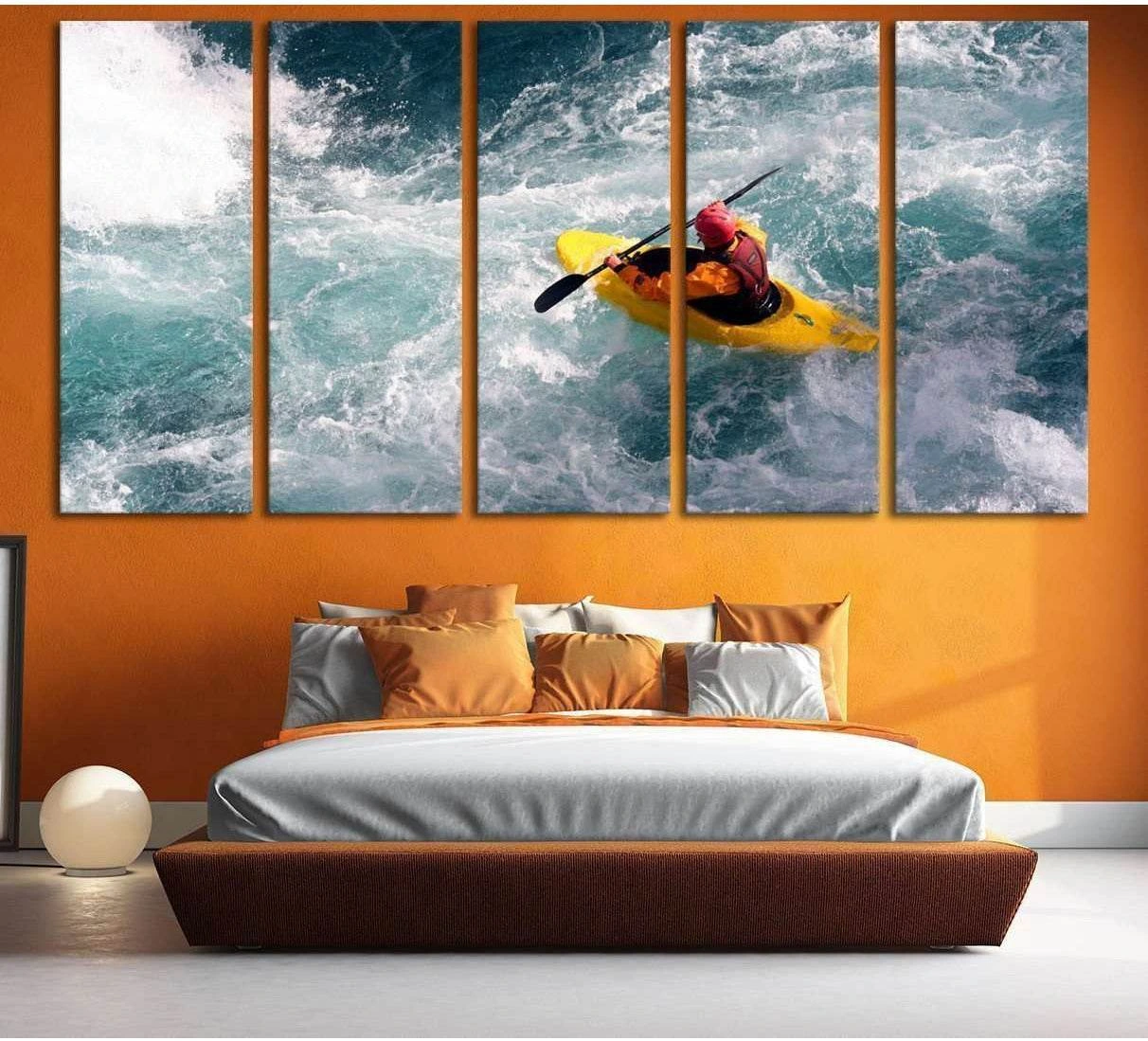 Yellow kayak in foaming teal ocean rapids multi-panel canvas print above a bed in a modern bedroom