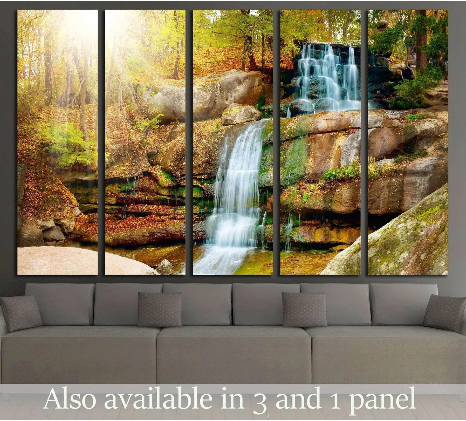 Autumn forest waterfall canvas print in multi-panel format displayed above a gray sofa