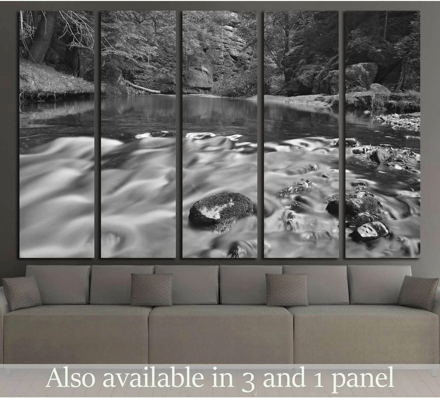 Black and white forest river canvas print with smooth flowing water above a living room sofa