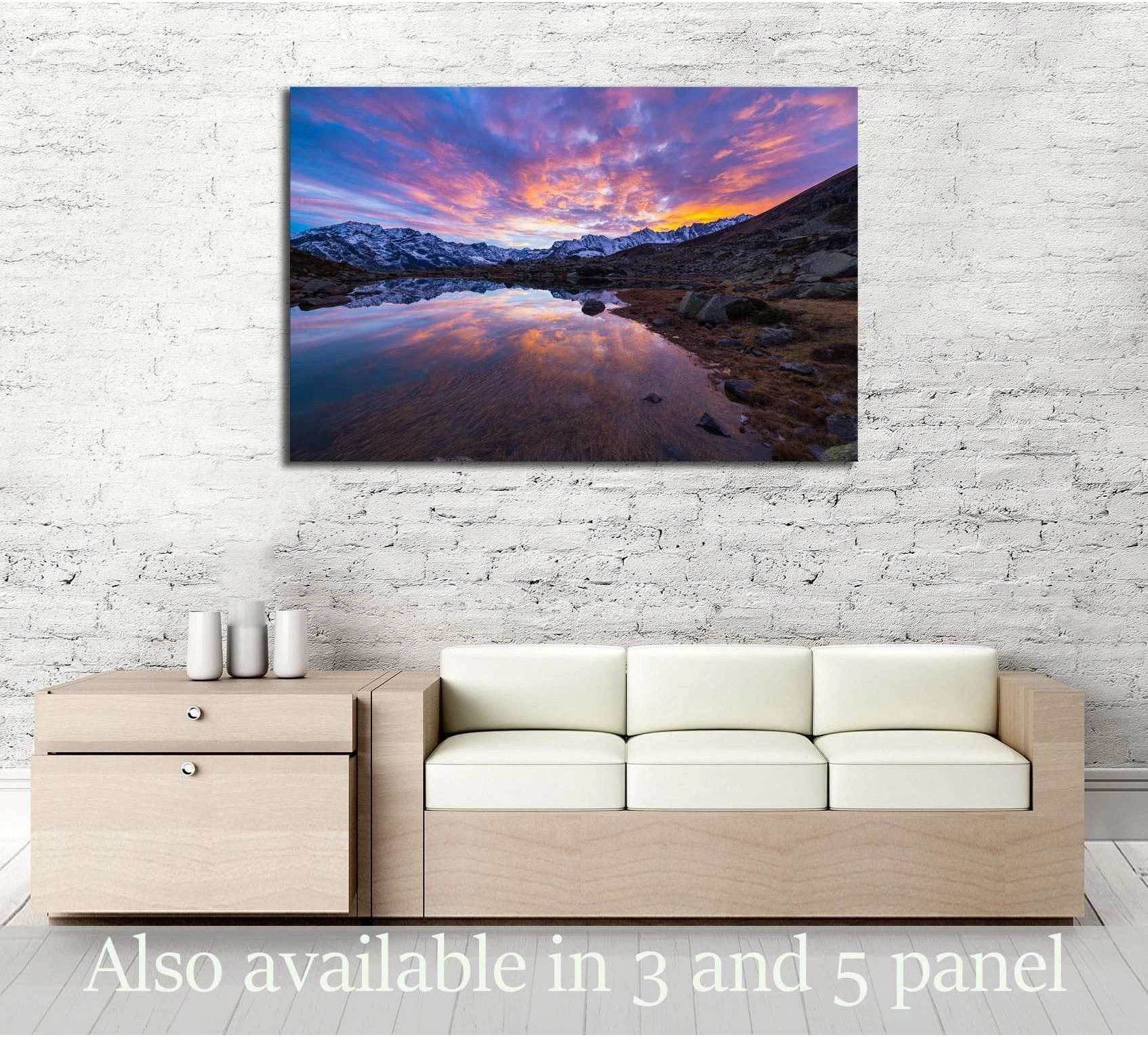 Italian Alps sunset canvas print above a sofa with alpine lake reflection and snow-capped peaks