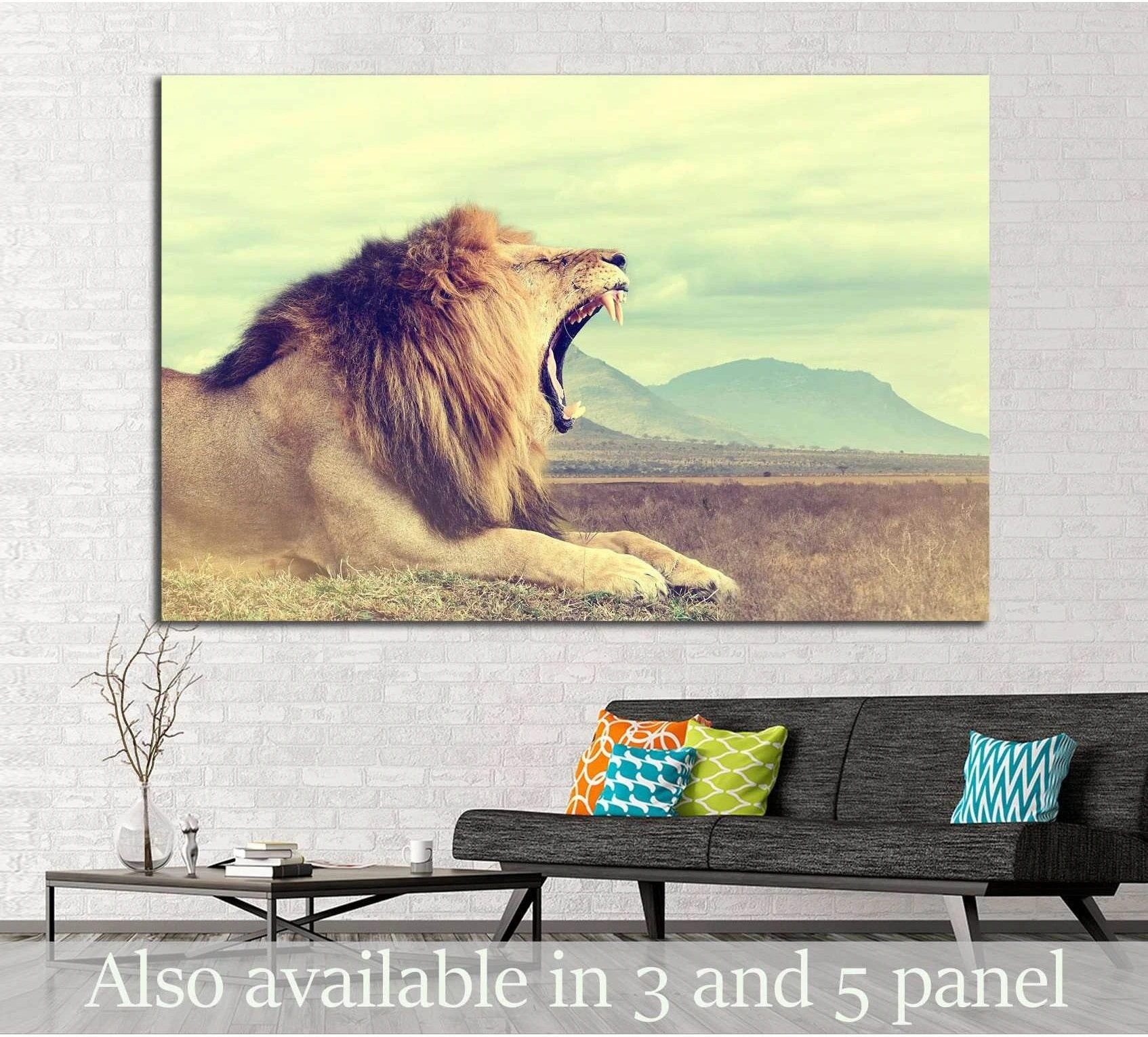 African lion canvas print with vintage safari tones, mountains behind, displayed above a sofa in a modern living room
