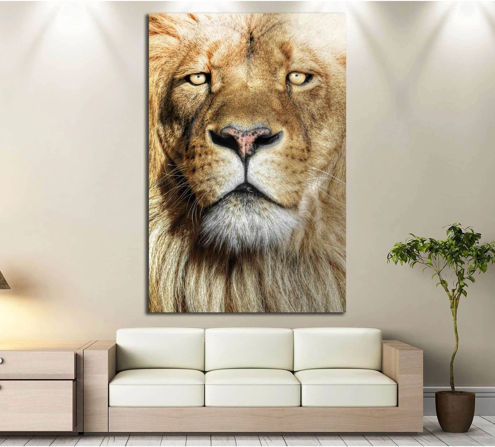 Close-up lion canvas print with golden mane and direct gaze above sofa in neutral living room