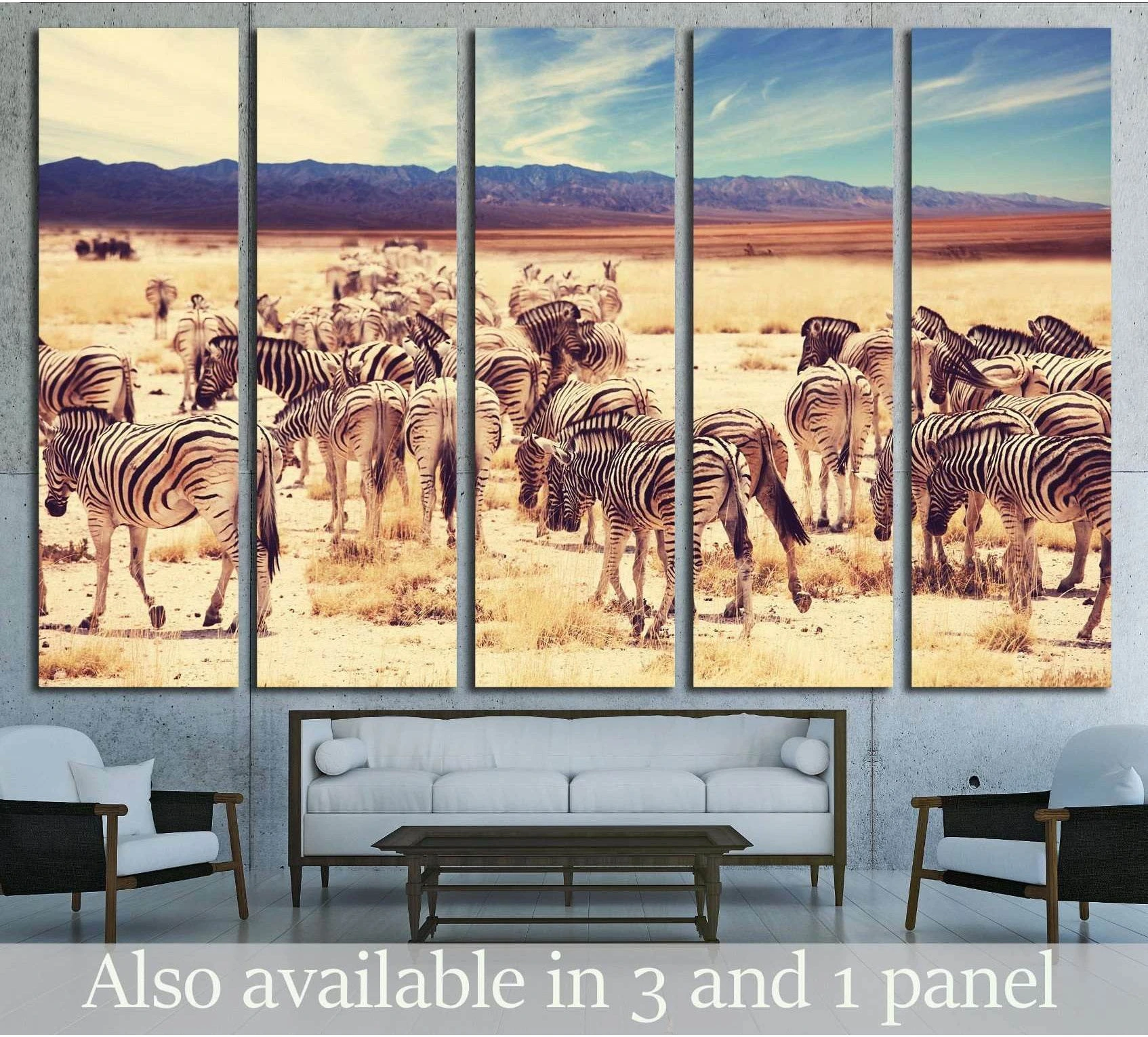 Zebra herd canvas print across a sunlit savannah, displayed above a sofa in a modern living room