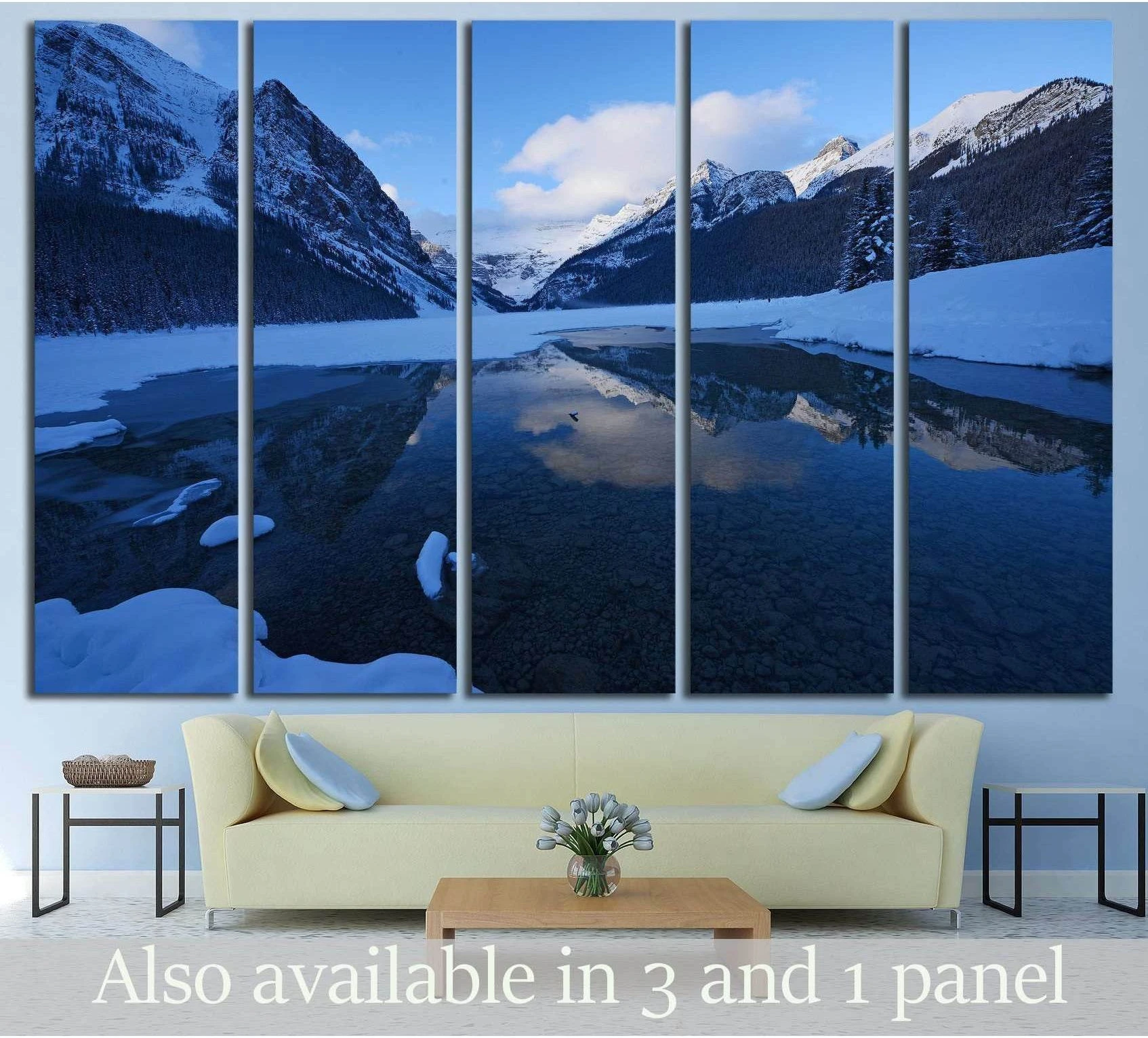 Lake Louise winter canvas print with snowy mountains and blue lake above a sofa