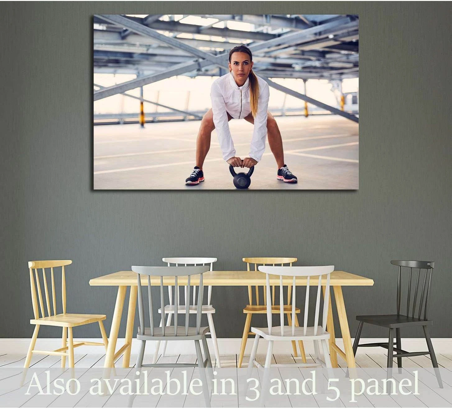 Woman with kettlebell in industrial gym setting canvas print displayed above dining table