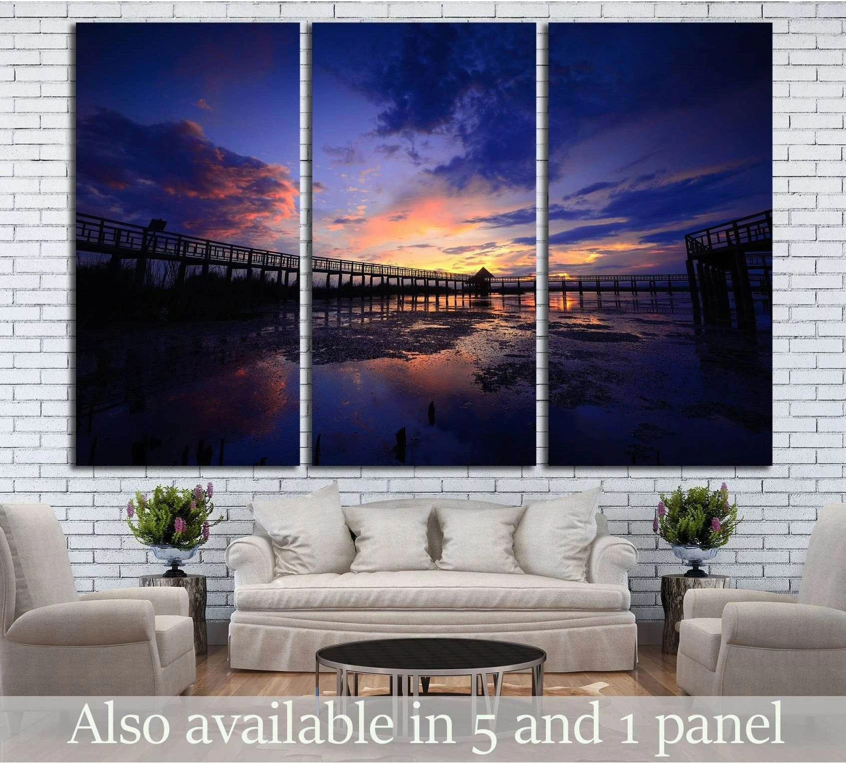 Thai boardwalk sunset canvas print over reflective wetlands, hung above a sofa in a modern living room
