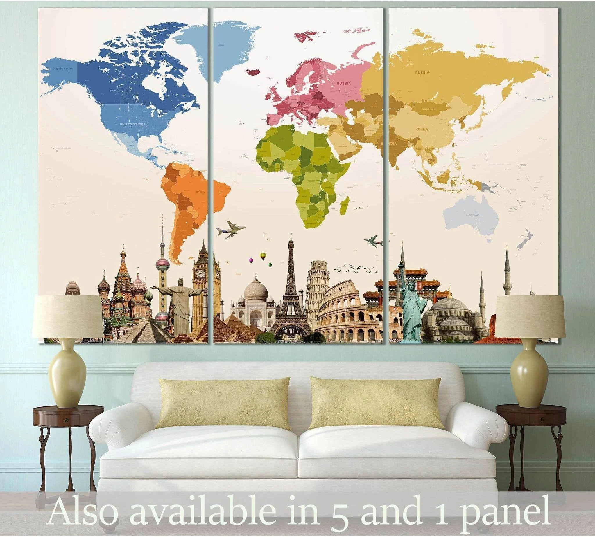 Colorful world map triptych canvas print with famous landmarks, displayed above a white sofa in a modern living room