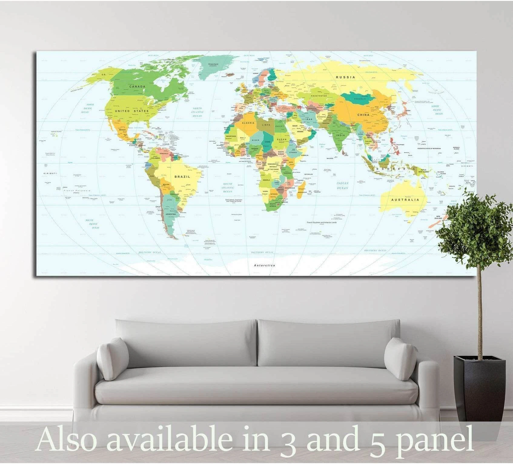 Pastel world map canvas print hung above a sofa in a modern office or living room