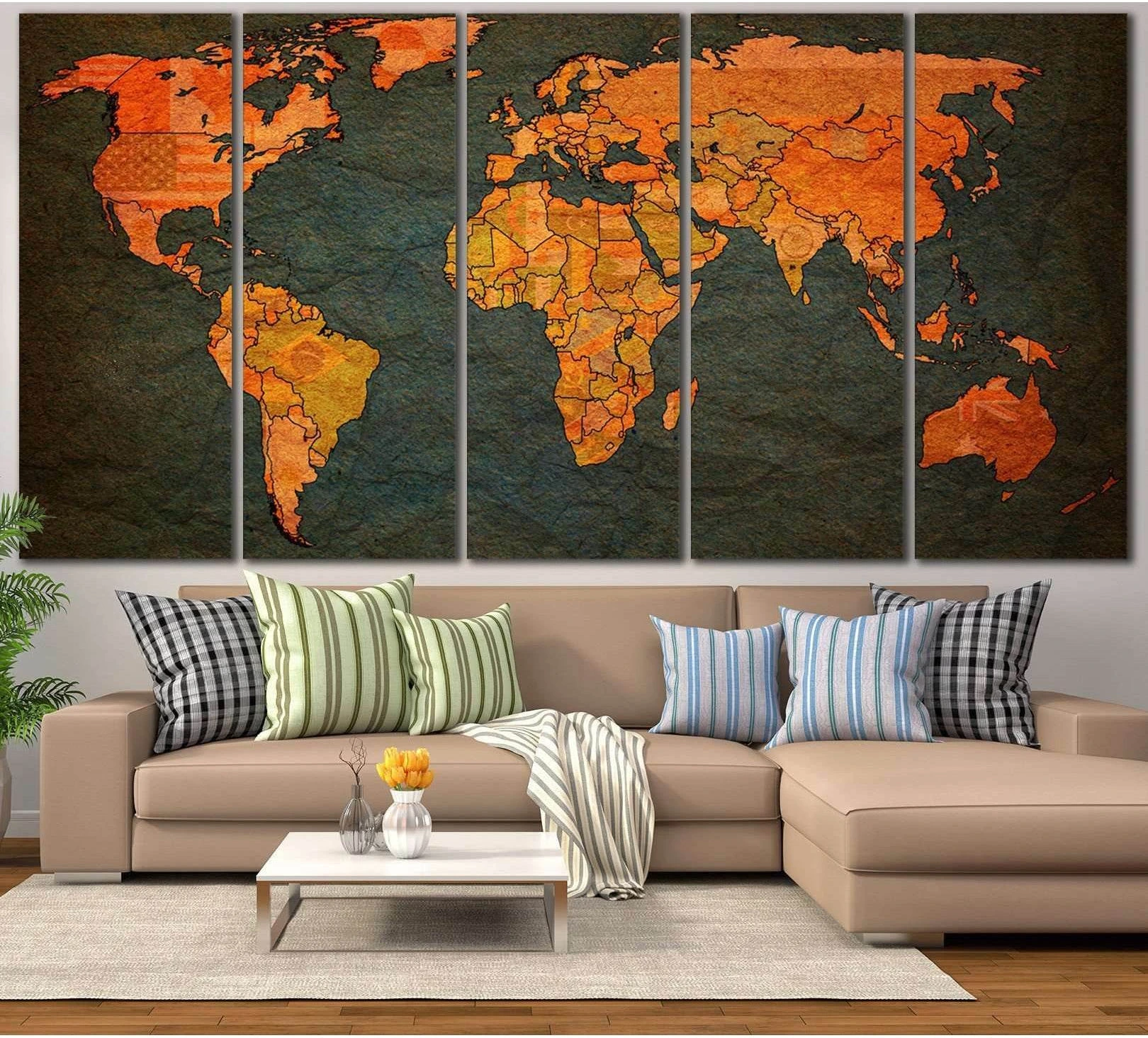 Vintage world map canvas print in warm orange and deep teal tones displayed above a beige sofa in a modern living room