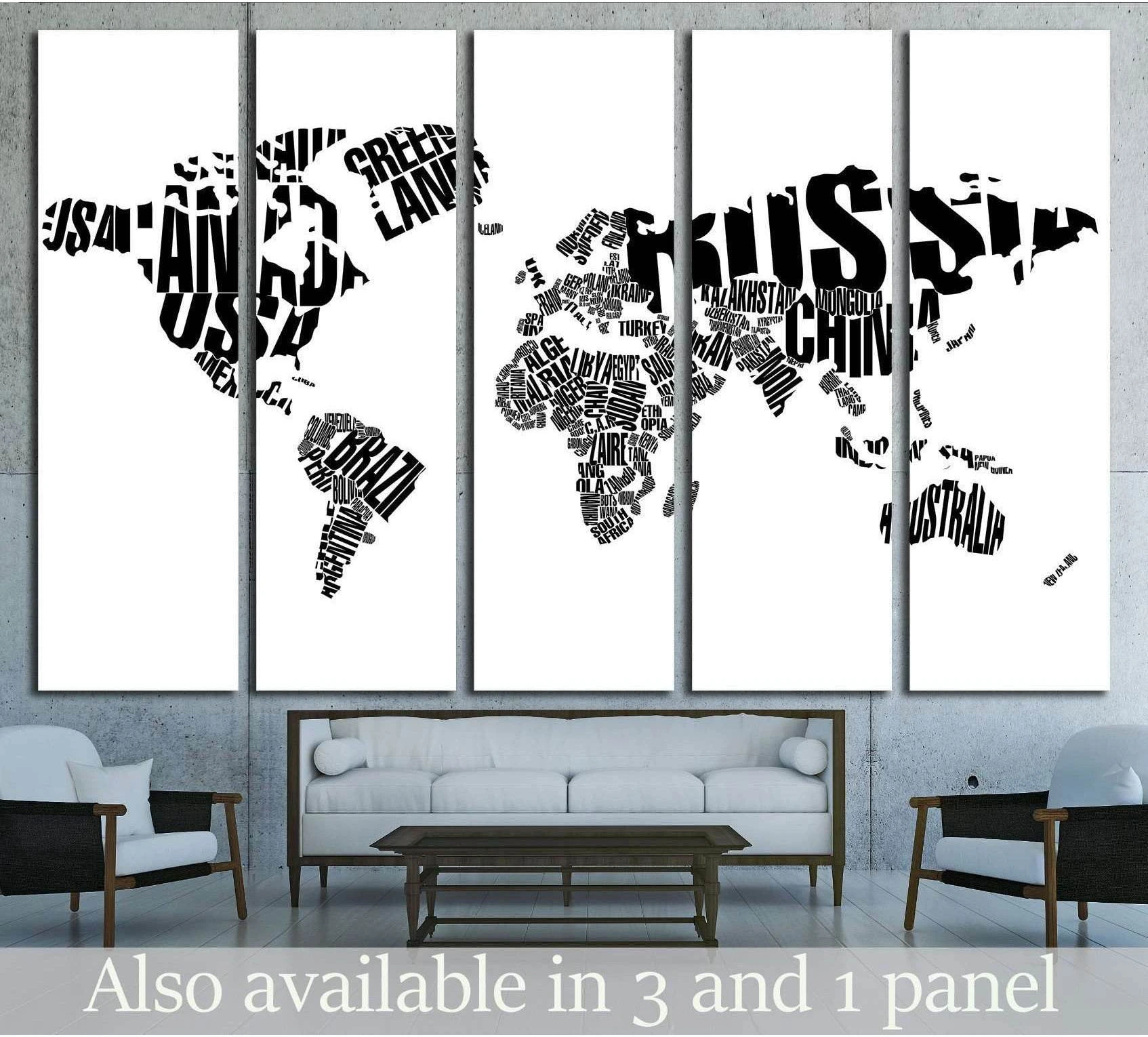 Black and white typographic world map canvas print hung above a sofa in a modern living room