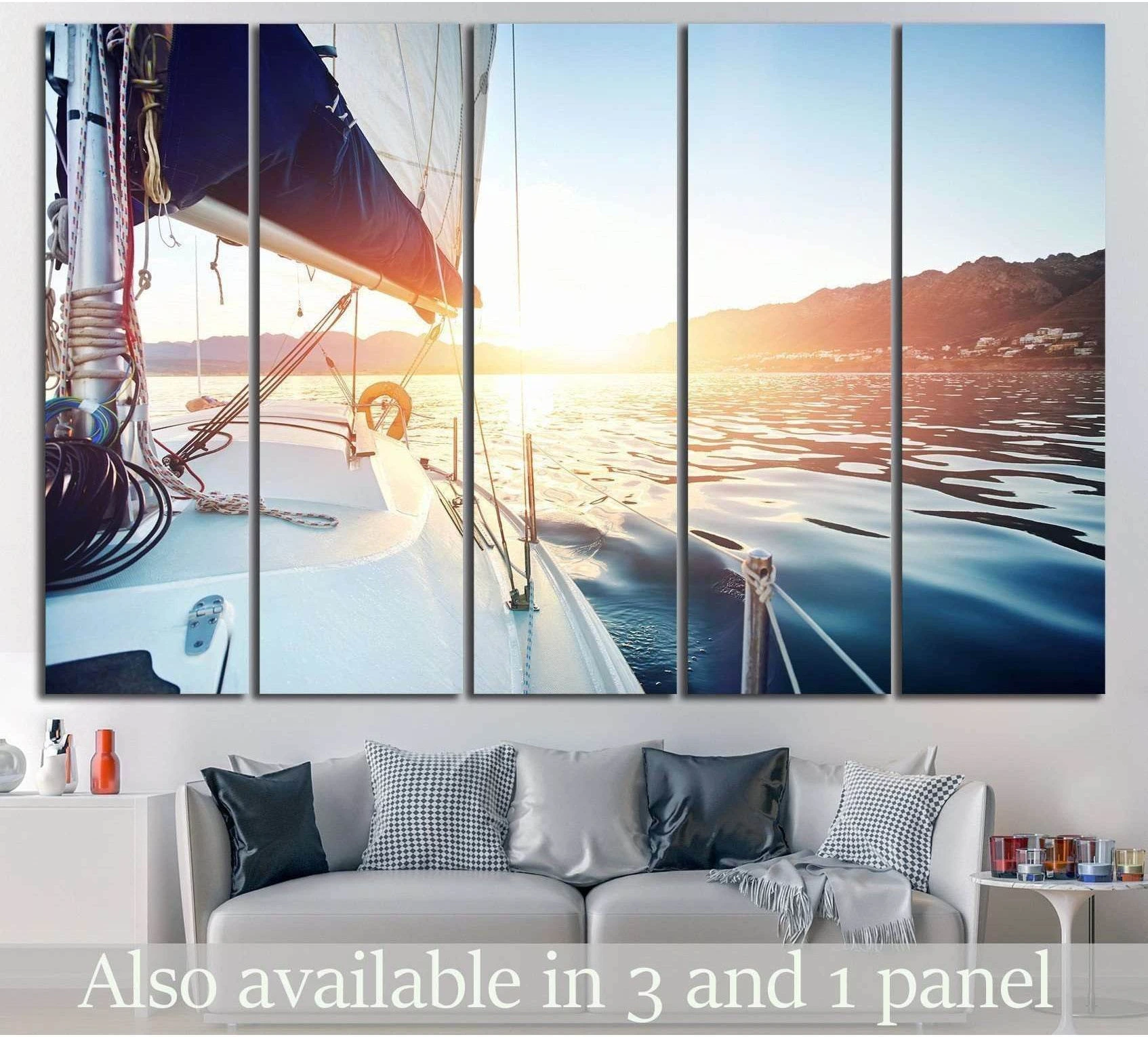 Sailboat canvas print of a yacht at sunset above a sofa in a coastal living room