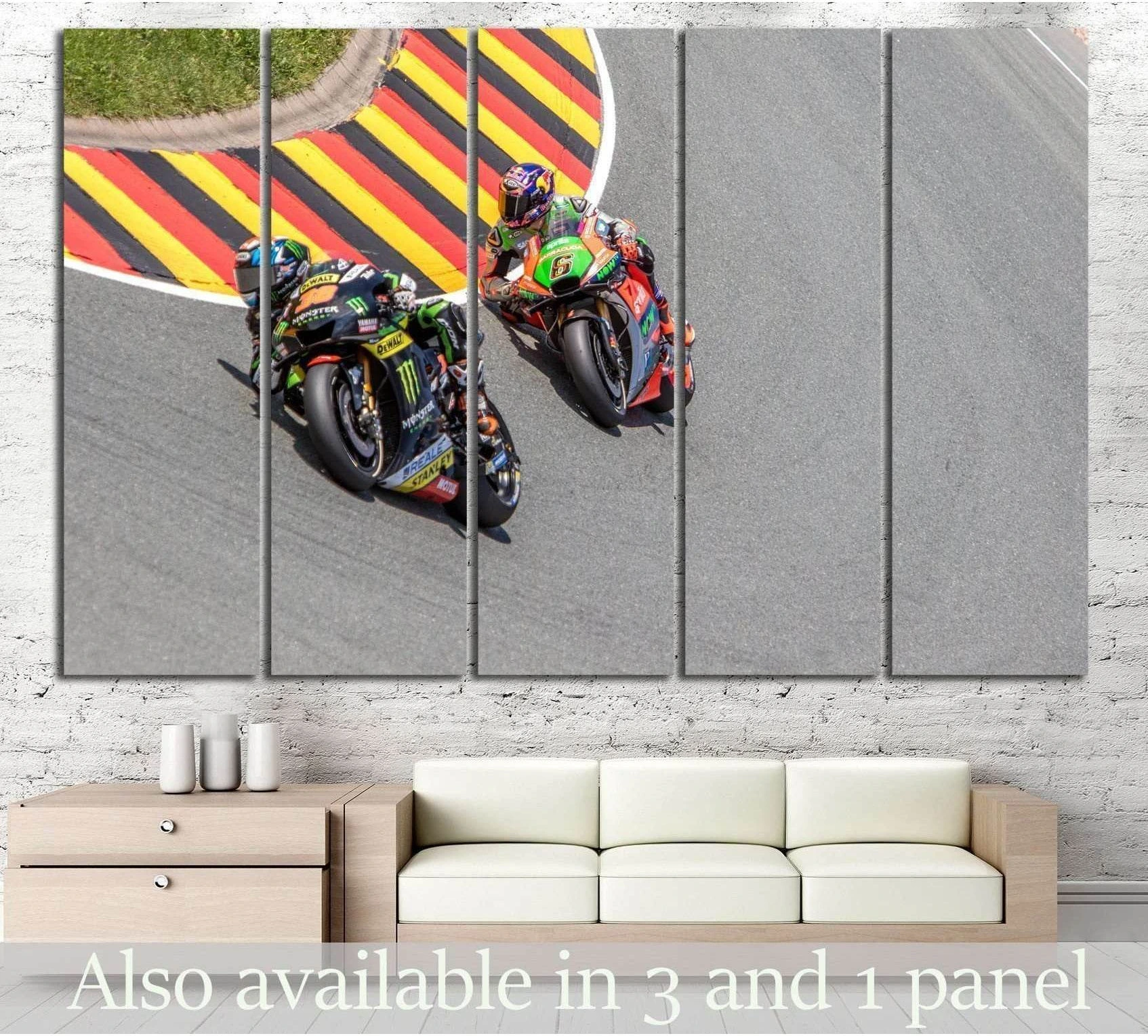 Two sport bikes leaning through a striped race track corner canvas print above a sofa in a modern room